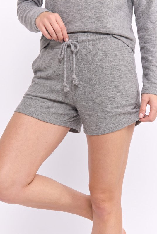 Model wearing Heather Grey drawstring knit shorts, front close-up view
