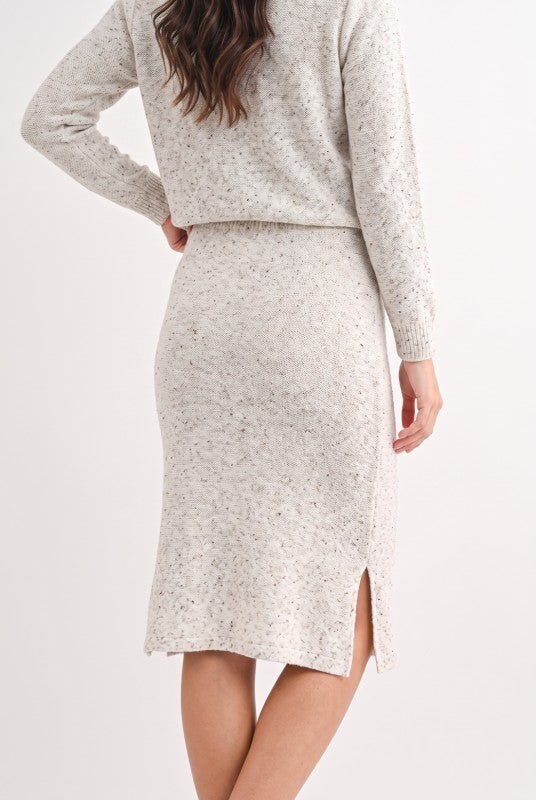 Model wearing oatmeal speckled knit midi pencil skirt, back view