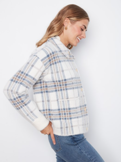 Woman wearing a plaid jacket and jeans on a white background