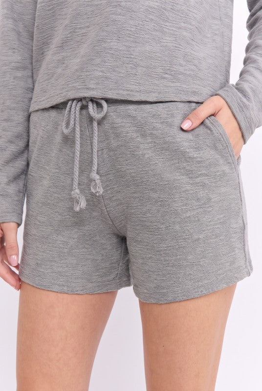 Model wearing Heather Grey drawstring knit shorts, front view showing drawstring and pocket
