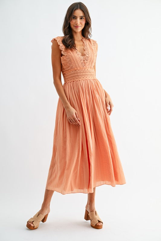 Model wearing orange lace boho midi dress, full front view