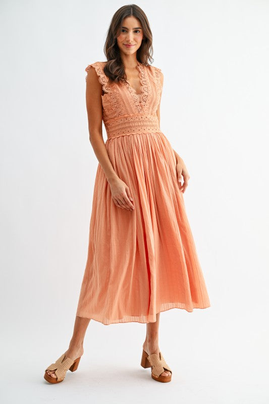 Model wearing orange lace boho midi dress, full front view