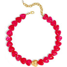 A heart-shaped beaded necklace featuring glossy hot pink heart beads with a central gold heart pendant and a gold chain extender clasp, shown on a plain white background.