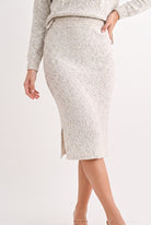 Close-up of oatmeal speckled knit midi pencil skirt showing elastic waistband and side slit detail