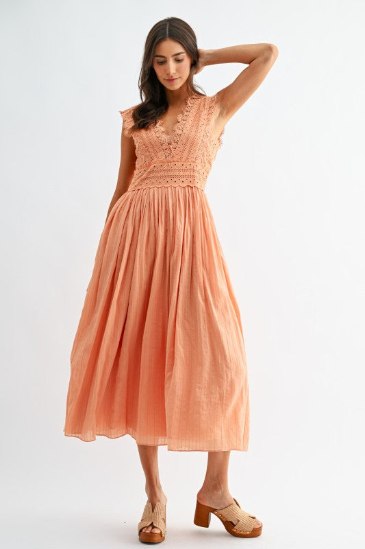 Model wearing orange lace boho midi dress, front view