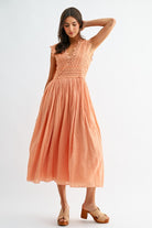 Model wearing orange lace boho midi dress, front view