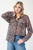 Woman wearing a leopard print shirt and jeans on a white background
