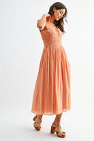 Orange lace boho midi dress, close-up of open V-back with tie detail