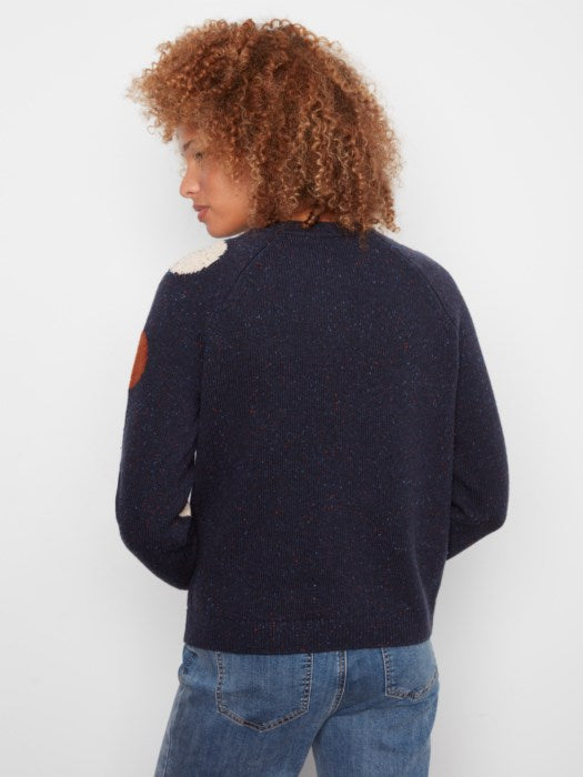 Person wearing a navy sweater with a white background