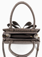 Gray handbag with gold accents on a white background