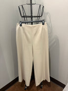 Beige dress pants on hanger 