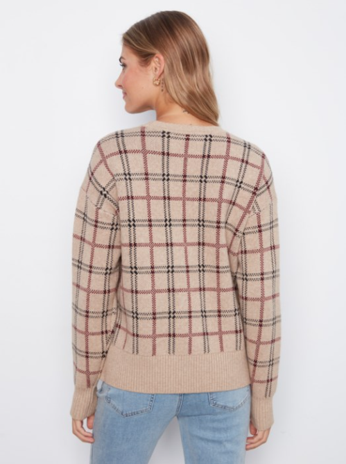 A woman shown from the back wearing a beige knit sweater with a brown and black plaid pattern, paired with light blue jeans, against a plain white background.
