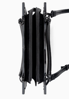 Black leather crossbody bag with multiple zippers on a white background