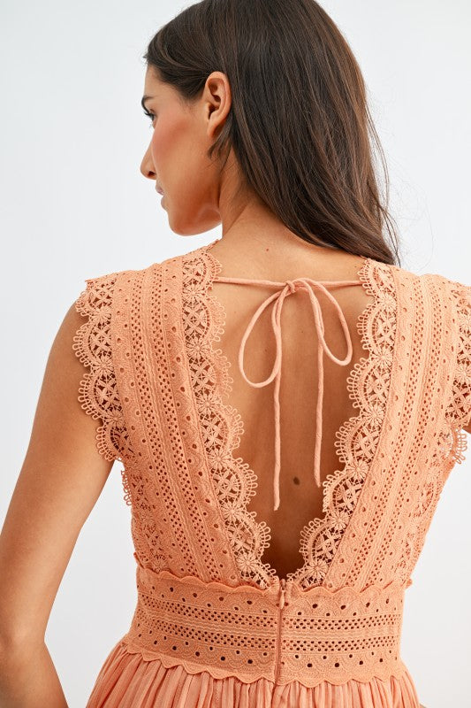 Model wearing orange lace boho midi dress, side view
