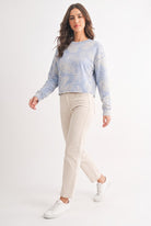 Model wearing dusty blue tropical print French terry crewneck sweatshirt, full length front view