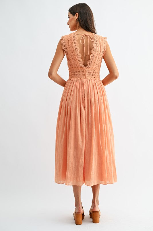 Model wearing orange lace boho midi dress, back view
